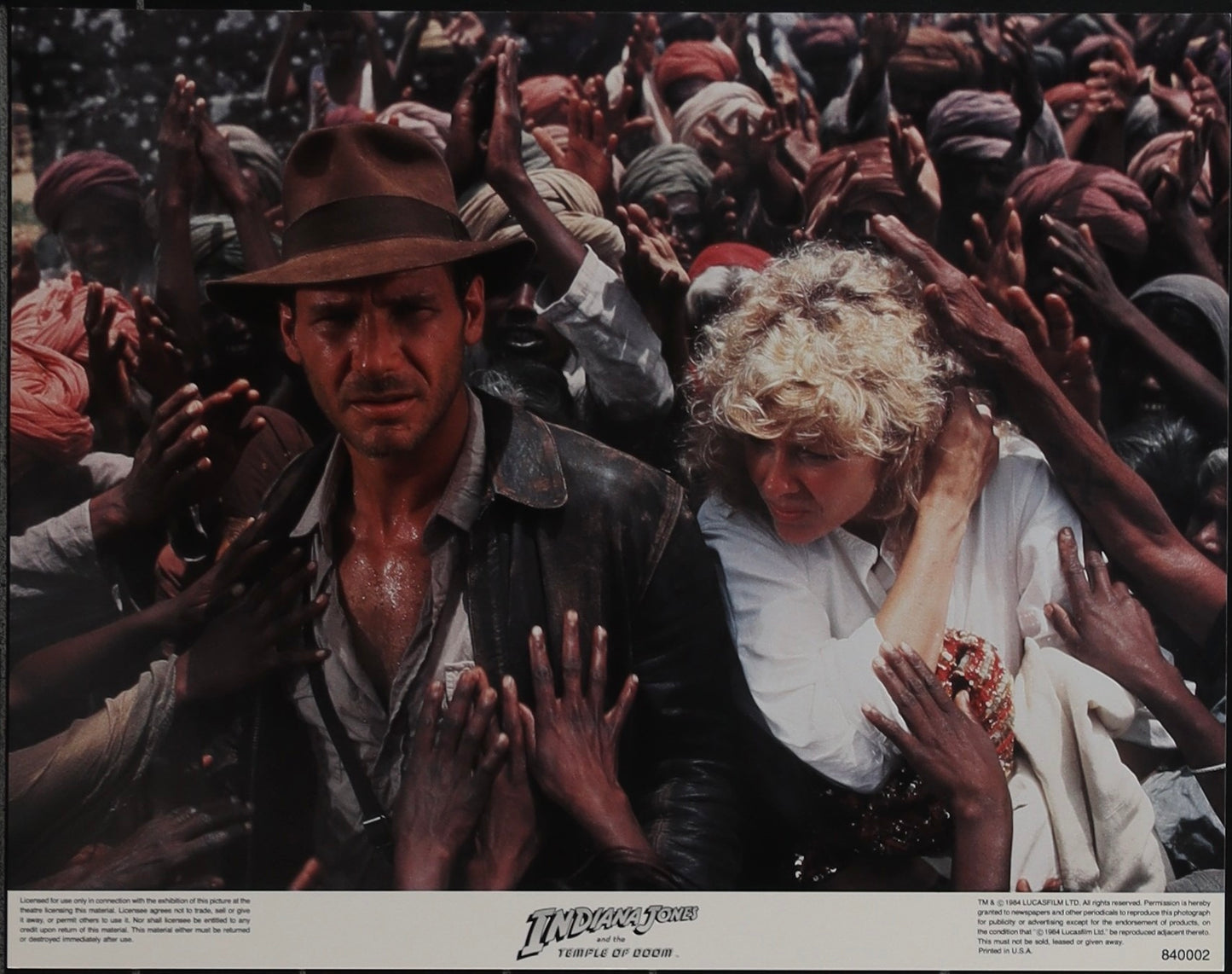 An original 11x14 lobby card / movie poster for the film Indiana Jones and the Temple of Doom