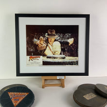 Load image into Gallery viewer, An original 11x14 lobby card for the film Raider of the Lost Ark