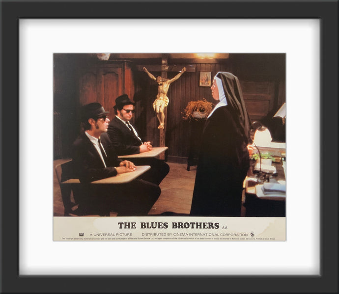 An original and framed lobby card for the film The Blues Brothers