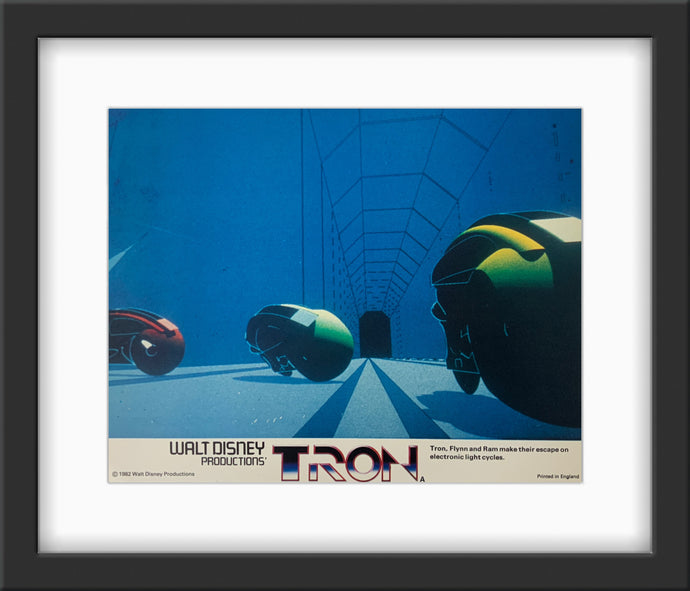 An original and framed lobby card for the Disney film Tron