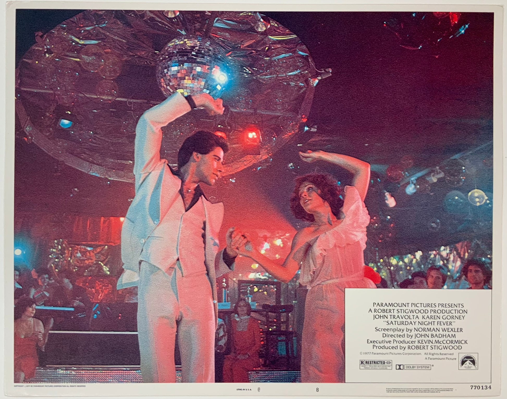 An original and framed 11x14 lobby card for the film Saturday Night Fever