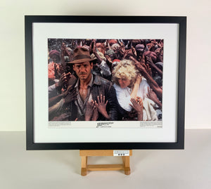 An original 11x14 lobby card / movie poster for the film Indiana Jones and the Temple of Doom