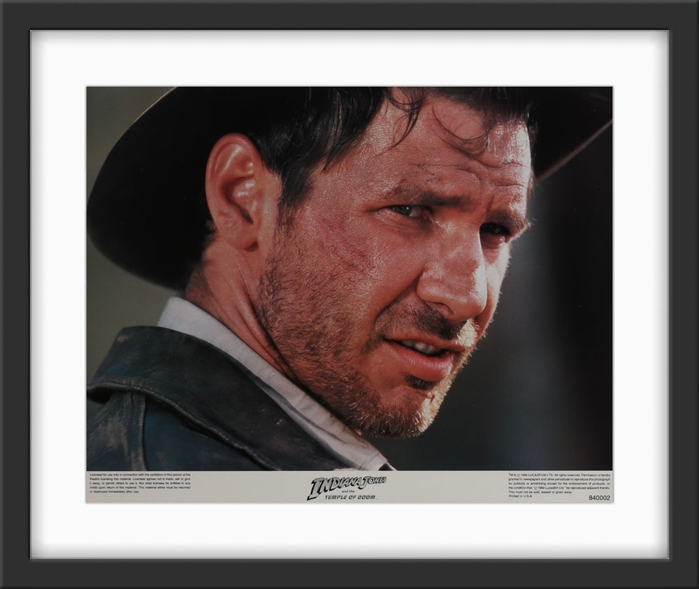 An original 11x14 lobby card / movie poster for the film Indiana Jones and the Temple of Doom