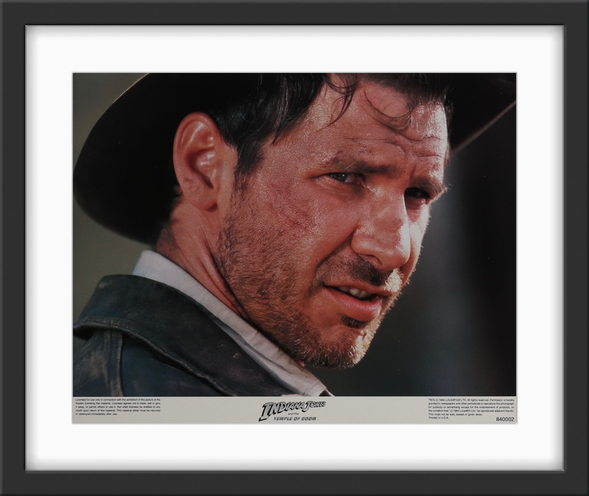 An original 11x14 lobby card / movie poster for the film Indiana Jones and the Temple of Doom