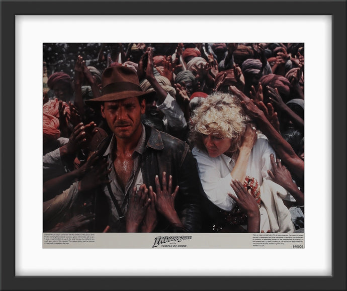 An original 11x14 lobby card / movie poster for the film Indiana Jones and the Temple of Doom