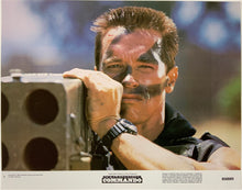 Load image into Gallery viewer, An original 11x14 lobby card for the Arnold Schwarzenegger film Commando