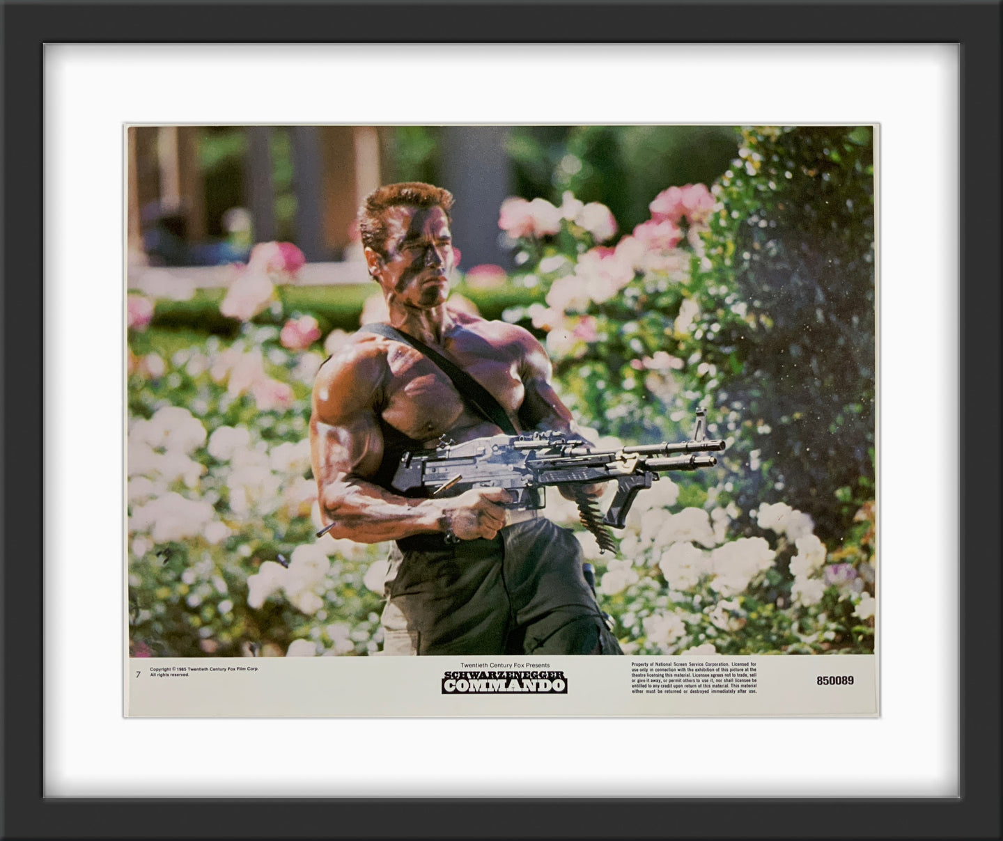 An original 11x14 lobby card for the Arnold Schwarzenegger film Commandofilm 