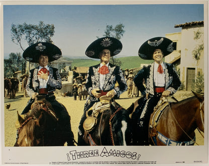 An original framed lobby card for the film Three Amigos