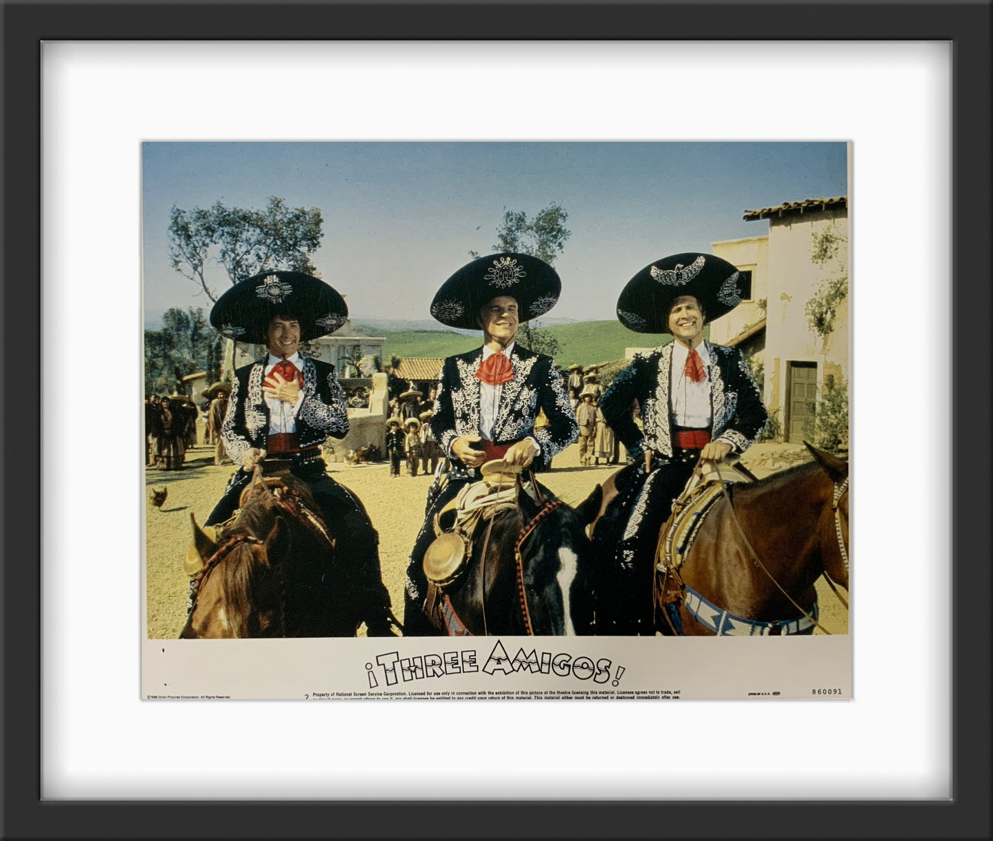 An original framed lobby card for the film Three Amigos