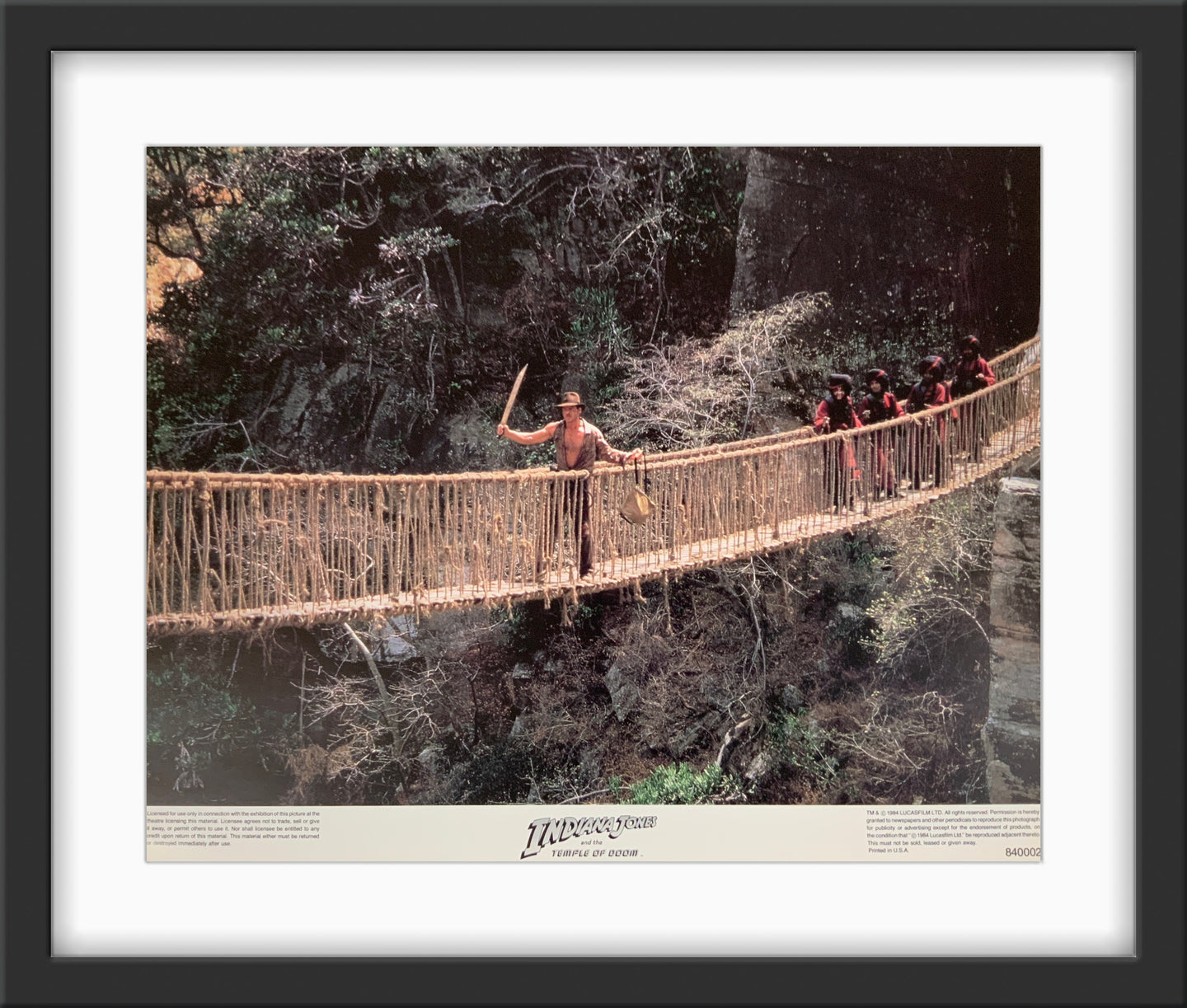 An original 11x14 lobby card for the film Indiana Jones and the Temple of Doom
