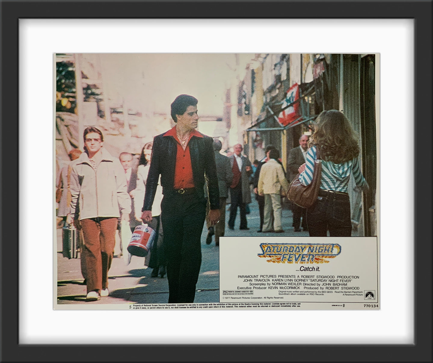 An original lobby card for the John Travolta movie Saturday Night Fever