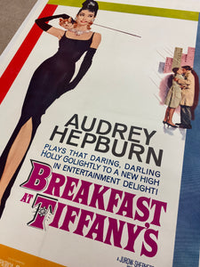 An original movie poster for the Audrey Hepburn film Breakfast At Tiffany's